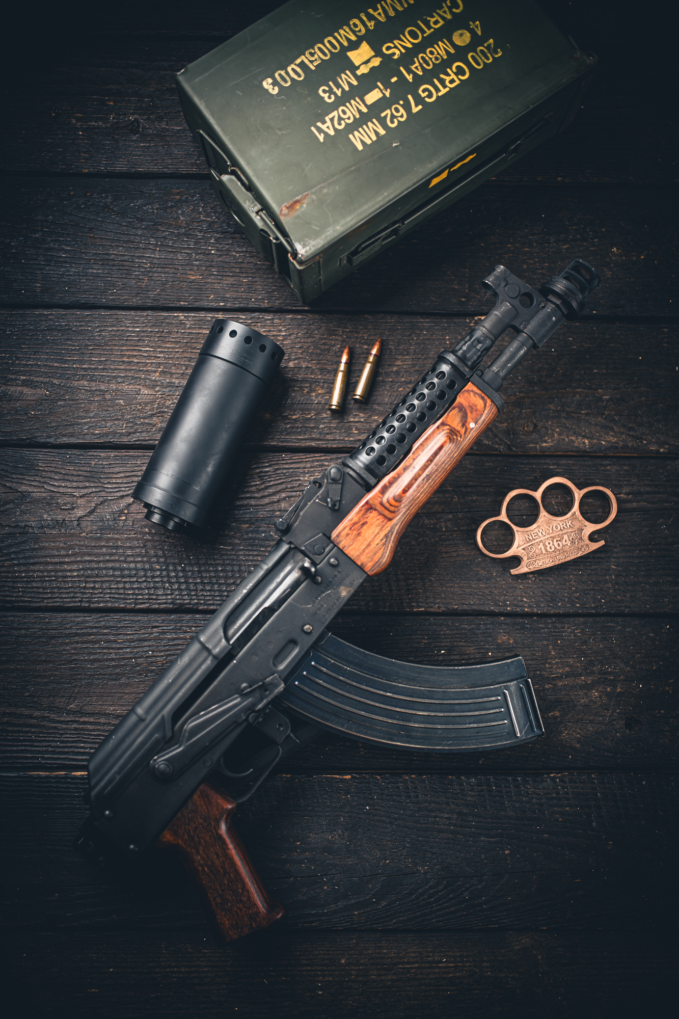 Suppressor and rifle flat lay with ammo can
