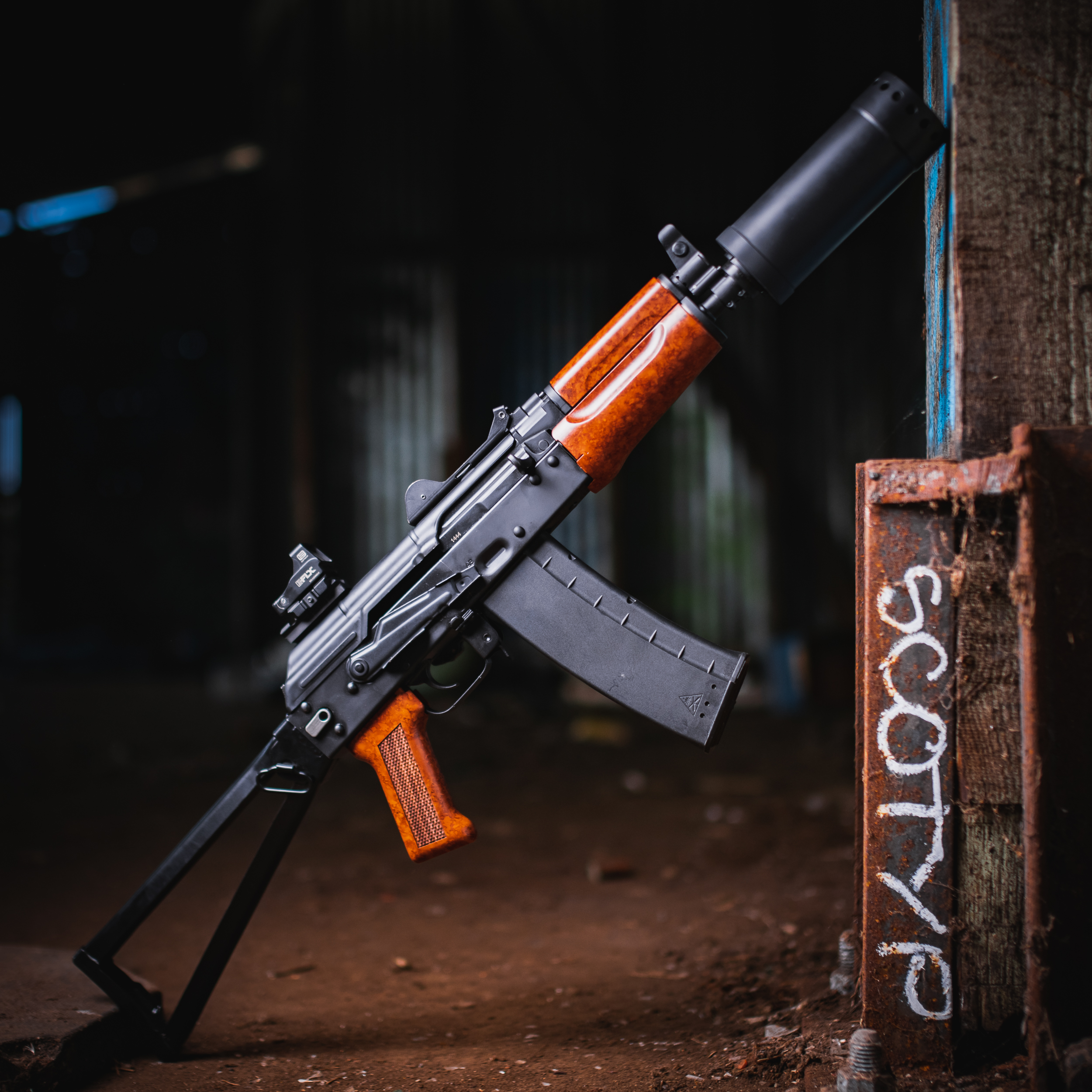 Suppressed rifle leaning in a workshop